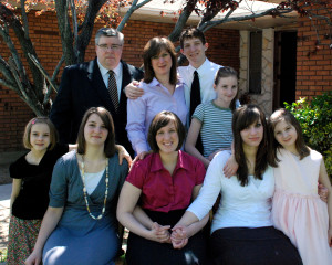 My family in 2009 as my eldest embarked on her mission. In this picture Aubree is in the center, age 23, to her left is Abby, age 17, then Emma at age 7. Allie is to Aubree's right, she is age 13 and next to her is  Madelyn, almost 9 in this picture. Maggie, age 11, is behind Abby. Enoch, age 15, is behind her. Sandy and I are both age 45 in this picture. 